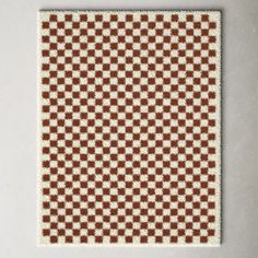 a brown and white checkered rug on a wall