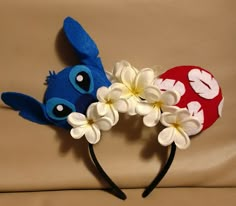 two blue and red ears with white flowers on them