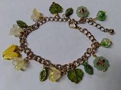 Embrace nature and whimsy with this fairycore-inspired charm bracelet, perfect for lovers of cottagecore, naturecore, and earthy aesthetics. Featuring an enchanting mix of glass and ceramic beads, this bracelet is adorned with delicate bee charms, pretty flowers, lush green leaves, and a cheerful yellow butterfly centerpiece. The chain is made from upcycled mixed metal, thrifted for an eco-friendly and sustainable touch. Ideal for those who enjoy magical, garden-inspired accessories, this unique piece adds a touch of woodland fantasy to any outfit. Size: Bracelet is adjustable up to 9 inches. Spring Bohemian Metal Bracelets, Bohemian Metal Bracelets For Spring, Bohemian Spring Bracelet, Whimsical Dangle Jewelry With Flower Charm, Handmade Bohemian Bracelets For Spring, Handmade Metal Crystal Bracelet As A Gift, Spring Bohemian Handmade Bracelets, Dainty Adjustable Spring Jewelry, Adjustable Dainty Spring Jewelry