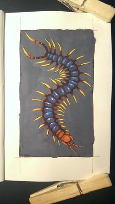 a drawing of a blue and yellow caterpillarl on a piece of paper