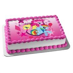 a birthday cake with pink frosting and an image of two ponies on it