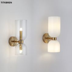 two wall lights with glass shades on them