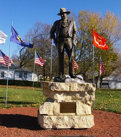 a statue of a man standing in front of flags