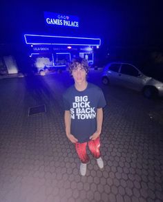 a young man standing in front of a game palace