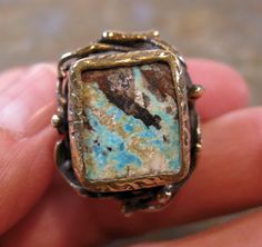 "A Beautiful Sterling Gilt Unique Artisan handmade Turquoise Ring Size 8. 13.61 Grams. Set Stone  Measures 5/8 x 2/8\" . Beautiful Gilt details with a lovely Ivy and Vine Naturalist Mount." Handmade Artsy Bronze Jewelry, Artsy Handmade Bronze Jewelry, Vintage Chrysocolla Rings For Gifts, Vintage Chrysocolla Rings As Gift, Unique Chrysocolla Rings As Gift, Unique Chrysocolla Rings For Gift, Unique Adjustable Turquoise Ring With Patina, Adjustable Turquoise Ring With Patina For Gift, Unique Bronze Rectangular Jewelry