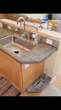 a kitchen with a sink, counter top and cabinets in the middle is being remodeled