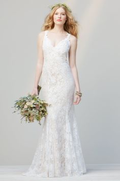 a woman in a wedding dress holding a bouquet