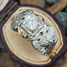 This vintage 32nd degree Masonic ring is centered with one (1) round brilliant cut diamond set into a four-prong setting. The shoulders of the ring features engraved double eagles. The ring measures 14.1mm at the top, rises 6.1mm above the finger, tapering to 4.8mm wide and 1.2mm thick at the base of the shank. It is currently a size 9.75. A bit of the enamel has worn over the years. Heirloom Engraved Round Cut Diamond Ring, Timeless Engraved Round Cut Diamond Ring, Diamond Mens Ring, Freemason Ring, Masonic Ring, Mens Ring, Diamond Set, Brilliant Diamond, Vintage Diamond