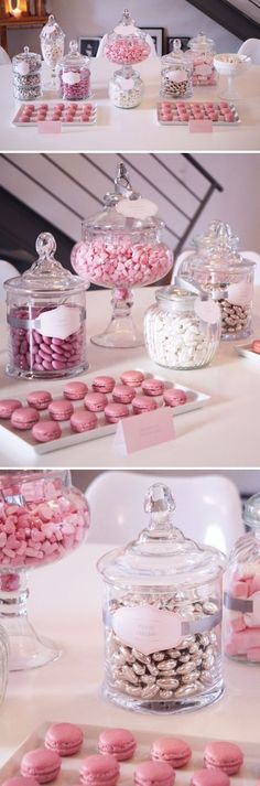 pink and white macaroons are on display in glass containers