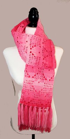 a pink knitted scarf on a mannequin