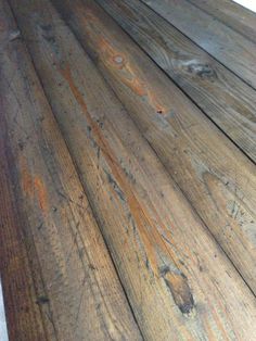 an old wooden floor that has been stripped and sanded with some paint on it