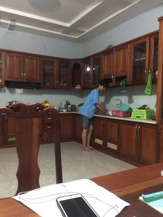 a man standing in the middle of a kitchen