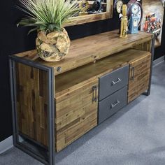 a wooden sideboard with metal handles and drawers