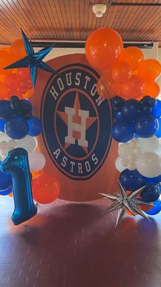 houston astros balloon arch with starfish and balloons on the floor in front of it