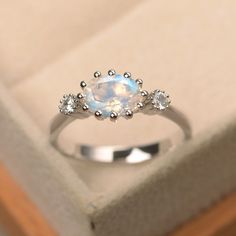 This ring features a 6*8mm oval cut moonstone and sterling silver finished with rhodium. Customization is available. It is made by hand, and it will take about 7 days to finish the ring after your payment is completed. Main stone: 6*8mm oval cut Moonstone Moonstone weight: Approx 1.2 ct Metal type: sterling silver finished with rhodium, 14k white/yellow/rose gold Accent stone: cz Customization is available, I also can make it with 14k solid gold (white or yellow or rose) and diamond accent stone Moonstone Engagement, Moonstone Engagement Ring, Ruby Engagement Ring, Blue Moonstone, Morganite Engagement Ring, Rose Engagement Ring, Jewelry Images, Silver Engagement Rings, Moonstone Ring