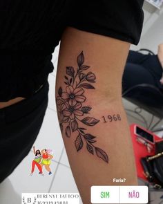 a woman with a flower tattoo on her arm