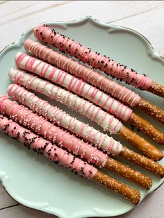 there are many different types of pretzels on the plate and one has sprinkles