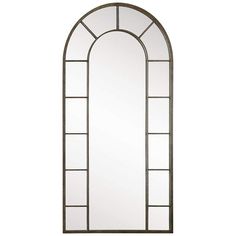 a large arched mirror sitting on top of a white wall