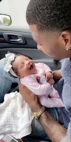 a man holding a baby in his lap