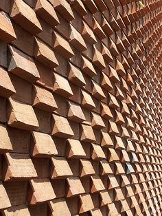 a close up of a brick wall made from wood planks