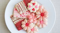 a white plate topped with cut up heart shaped cookies