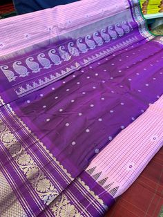 Beautiful pure Gadwal silk saree with  checkered body and floral motifs and a  contrast purple border floral vine design and a grand  zari pallu.  Handloom saree  Comes with a  silk blouse piece . Dry clean only Purple Saree With Weaving Work For Festive Occasions, Bollywood Style Purple Saree With Weaving Work, Festive Purple Saree With Weaving Work, Purple Saree With Traditional Patterns In Paithani Silk, Purple Traditional Wear With Weaving Work For Festivals, Bollywood Style Purple Traditional Wear With Weaving Work, Purple Traditional Wear With Weaving Work For Diwali, Purple Traditional Wear With Weaving Work For Ceremonies, Purple Wedding Dupatta With Weaving Work