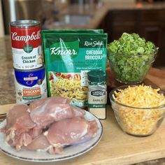 ingredients to make chicken broccoli salad on a counter with bowls of shredded cheese