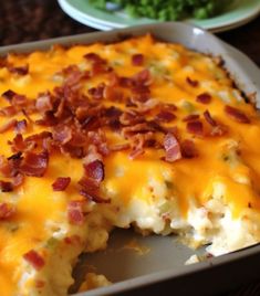 a casserole dish with bacon and cheese on it, ready to be eaten