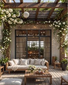 an outdoor living area with white flowers and greenery