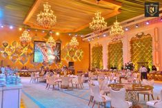 an elaborately decorated banquet hall with chandeliers and tables