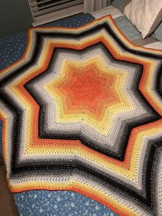 a crocheted blanket on top of a bed