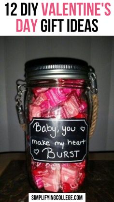 a glass jar filled with candy wrapped in pink and red bows, sitting on top of a table