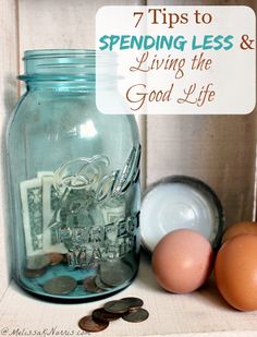 an egg and some coins on a table with the words 7 tips to spending less & living the good life