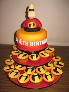 the birthday cake is decorated with cupcakes as well as an image of mr incredible