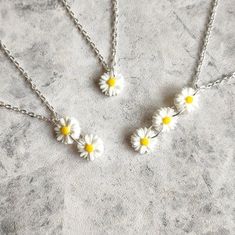 Feel as fresh as a daisy this Summer with my beautiful acrylic flower Collection! Featuring dainty little resin daisies, necklaces and earrings are available in single, double or triple drops! Daisy charms are handmade from super lightweight resin and measure 1.2cm each Single Daisy: 1.2cm drop Double Daisy: 2.5cm drop Triple Daisy: 3.8cm drop Choose your perfect number of daisies in either a necklace or earrings- or purchase together and save! Necklace length measures approx 16-18" and fastens Cute White Flower Jewelry, Cute White Jewelry With Flower Charm, Cute White Jewelry With 3d Flowers, Cute White Birth Flower Jewelry, Daisy Flower Charm Earrings As Gift, Cute Daisy-shaped Summer Jewelry, Gold Daisy Earrings With Flower Charm, Daisy Flower Pendant, Cute Daisy-shaped Jewelry With Flower Charm