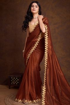 Enhance your ethnic charm by wearing this dark brown organza silk saree which will make you ready to make a statement on the upcoming occassion.This u-neck and sleeveless blouse is accentuated with zari and sequins work.It is matched with a lightweight organza silk saree in dark brown color designed with dori, sequence, and muqayyash work.This saree blouse can be customized up to the maximum size available in inches 58 around the bust.Slight color variation may occur due to photographic reasons. Dark Saree, Brown Net Saree, Dark Brown Saree, Rust Saree, Organza Silk Saree, Net Saree, Dark Brown Color, Saree Blouse, Sleeveless Blouse