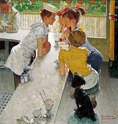 three women sitting at a table talking to each other