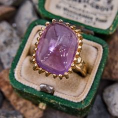 This stunning handmade vintage ring features a rectangular sugarloaf style amethyst cabochon in a twenty-six prong setting. The ring is crafted in a soft 14k yellow gold and is currently a size 7. Luxury Purple Amethyst Ring, Rectangular Shape, Luxury Purple Amethyst Rectangular Ring, Luxury Purple Rectangular Amethyst Ring, Art Deco Amethyst Ring In Yellow Gold, Classic Yellow Gold Rectangular Amethyst Ring, Yellow Gold Amethyst Ring In Art Deco Style, Rectangular Amethyst Ring In Yellow Gold, Yellow Gold Amethyst Ring With Rectangular Shape, Art Deco Yellow Gold Amethyst Ring