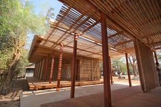 the inside of a building with wooden slats on it's sides and people walking around