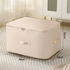 a white storage box sitting on top of a rug