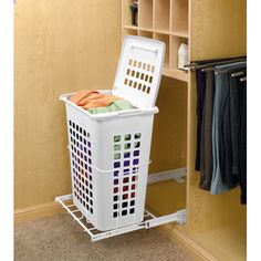 a white laundry basket sitting inside of a closet