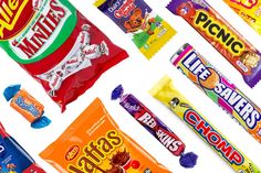 many different types of candy bars on a white background