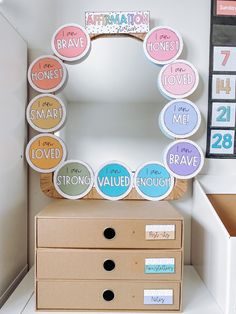 a mirror sitting on top of a dresser next to a box filled with magnets