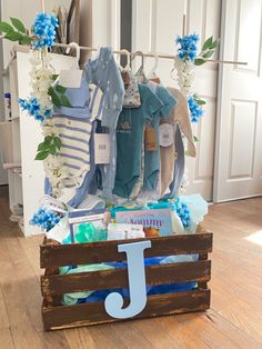 a wooden crate filled with baby items on top of a hard wood floor next to a white door