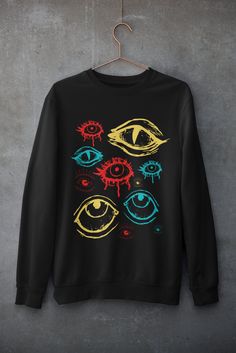 Thanks for stopping by! Clowncore eyes sweatshirt Please size up by one or two sizes for an over sized look Usually dispatched in 5 working days ECO-FRIENDLY Each garment is made to order, reducing extra material and energy that would be otherwise wasted We use DTG printing process which is easier on the environment than screen-printing Our ink is bright and also eco-friendly. Material: 80% ringspun cotton/20% polyester. - Drop shoulder style. - Stylish fit. - Soft cotton faced fabric. - Taped n Eye Fashion Clothes, Eye Clothing, Eye Sweater, Dreamcore Fashion, Clowncore Clothes, Clowncore Aesthetic Outfits, Dark Clowncore, Weird Clothing, Weirdcore Aesthetic Outfits