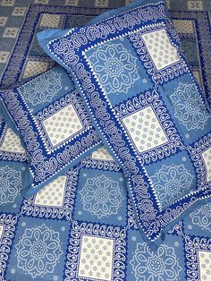 four blue and white bandana style pillows