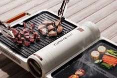 an electric grill with meat and vegetables cooking on it