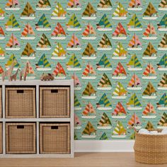 a wallpaper with colorful sailboats on it in an empty room next to a wicker basket