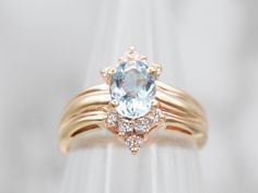 This beautiful yellow gold ring is set with an aquamarine center stone and accented with sparkling diamonds. The perfect gift, this design combines a classic look with modern sophistication.Metal: 14K Yellow GoldGem: Aquamarine .64 CaratsGem Measurements: 4.9 x 6.9 mm, OvalAccents: 10 Diamonds totaling .30 Carats, SI in Clarity, G-H in ColorRing Size: 5Marks: "14KP" Stamped on the inside band Dinner Ring, Pocket Watch Chain, Watch Chain, Aquamarine Rings, Yellow Gold Ring, Sparkle Diamonds, Pearl Pendant, Charm Earrings, Yellow Gold Rings