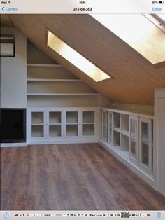 an empty room with wooden floors and skylights on the ceiling is seen in this image